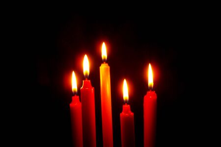 Red candle on a black background in the dark, close-up,Candles , Burn candles at night Candle light on black backgroundの写真素材