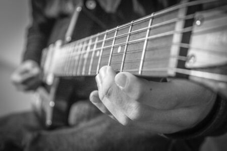 nice selective focus shot of guitarist playing guitarの写真素材