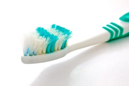 a used toothbrush on white background