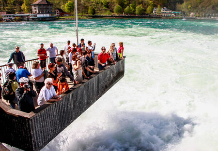 tourists at the observation deck at Rhine fall, the biggest waterfall in Europe, Switzerlandのeditorial素材