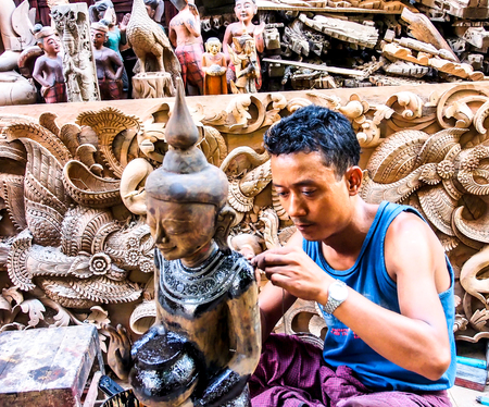 wood carver work in a souvenir shop in Mandalay, Myanmarのeditorial素材