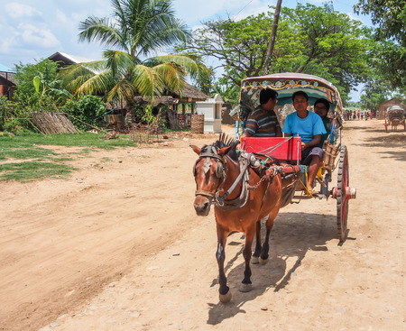 tourists ride horse carriage at Ava ancient city in Myanmarのeditorial素材