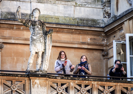 tourists with the old Roman sculpture at Bath, Somerset, UKのeditorial素材