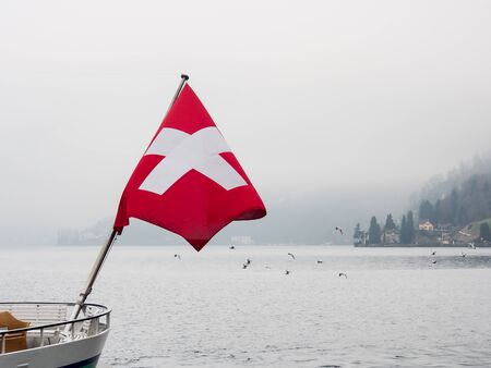 Swiss flag at the boat in lake Luzern, Switzerlandの写真素材