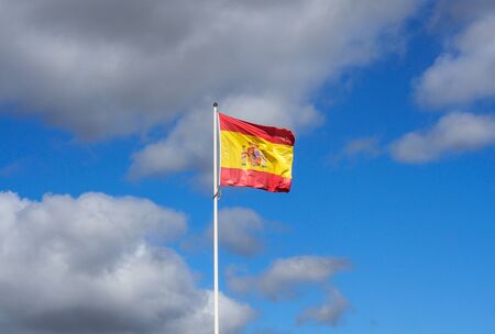 Spanish flag with blue skyの写真素材