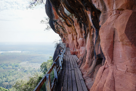beautiful wooden walk way beside a mountain in Thailandの写真素材