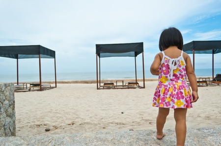 Little asian girl walking to the beachの写真素材