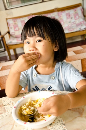 Little asian girl eating her lunchの写真素材