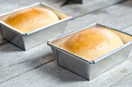 Fresh breads baked in tray on wood table