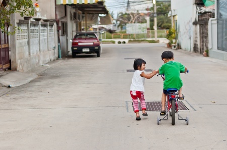 Brother and sister have fun with bicycle, love, relation ship, take care conceptの写真素材