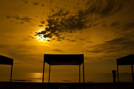 Beach beds and tent at colorful dawnの写真素材