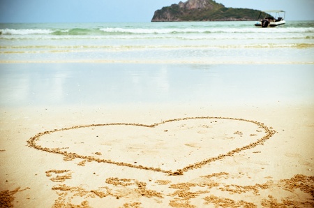 Heart drawn on sand of Thailand beachの写真素材