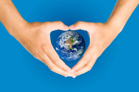 Hand holding the blue Earth  Elements of this image furnished by NASAの写真素材