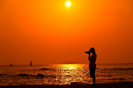 Photographer with sillouette on Hua Hin Beachの写真素材