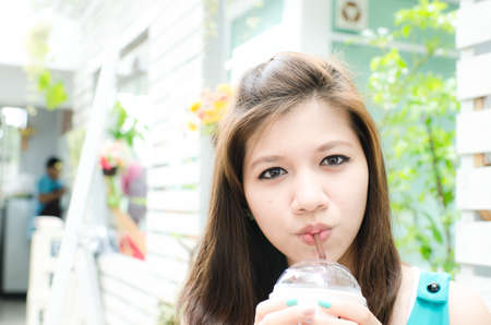 Beautiful woman enjoy her drinkの写真素材