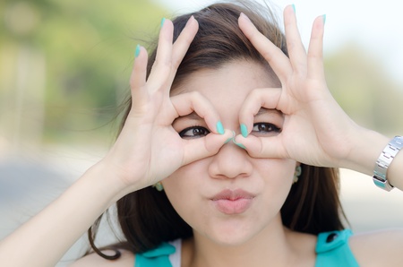 Happy woman with a naughty wink outdoorの写真素材