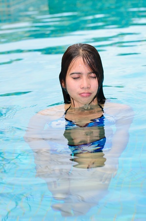 Asian woman in swiming poolの写真素材