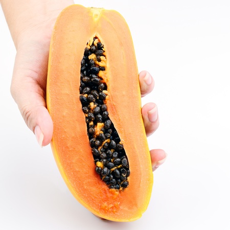 Hand holding Papaya on white backgroundの写真素材
