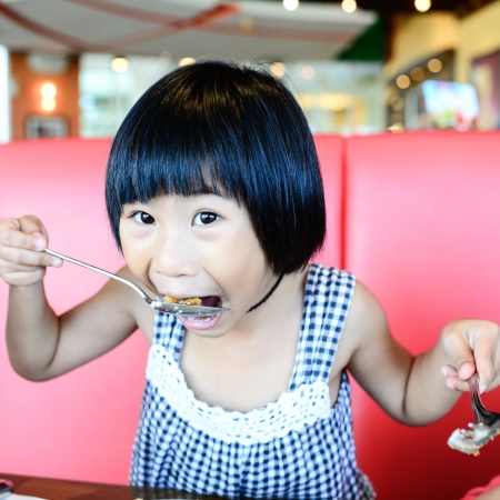 Girl eating fish fingerの写真素材