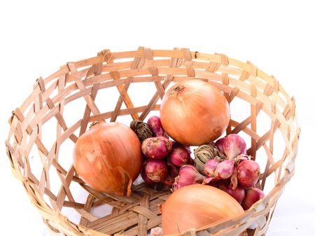 Onions with basket on white backgroundの写真素材