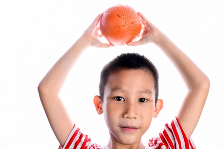 happy asian boy playing basketballの写真素材