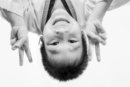 Boy Lying On Bed with victory fingers.の写真素材