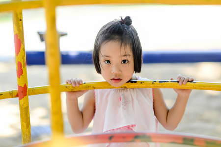 Asian little kid playing in the amusement parkの写真素材