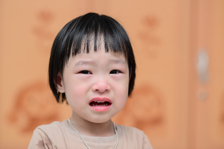 portrait of a cute little girl cryingの写真素材