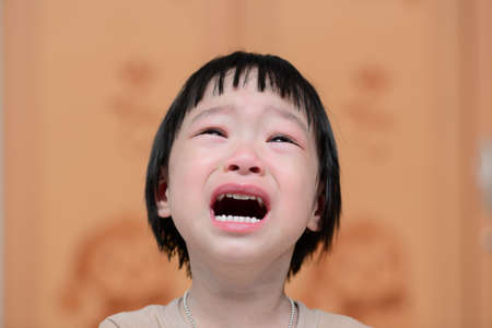 portrait of a cute little girl cryingの写真素材