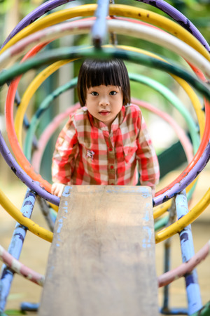 Asian little kid playing in the amusement parkの写真素材