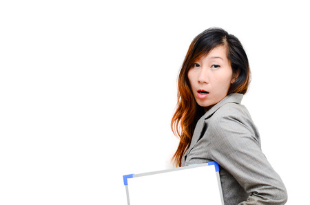 Business woman hold white blank paper. Smart Asian woman show blank board with surprise face isolated on white background.の写真素材