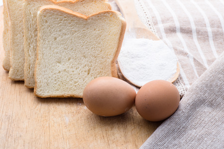bread and wheat on the wooden background