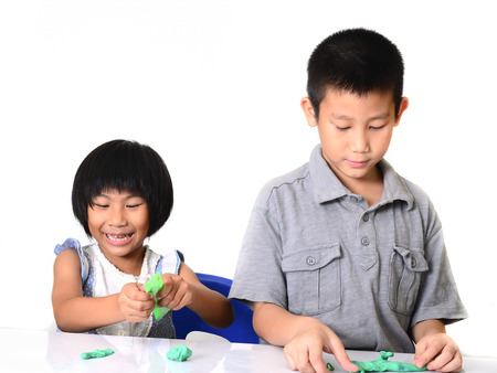 Asian children playing clay at home.の写真素材