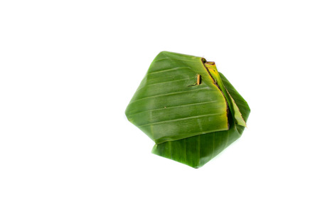 Thailand dessert wrapped in banana leaves isolated on white backgroundの写真素材
