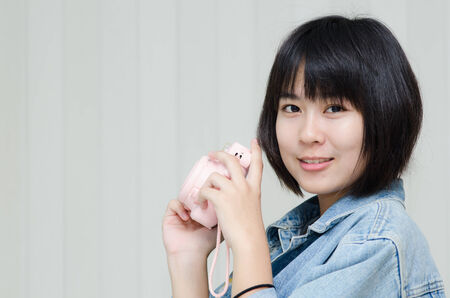 Asian teenager with fashion camera.の写真素材