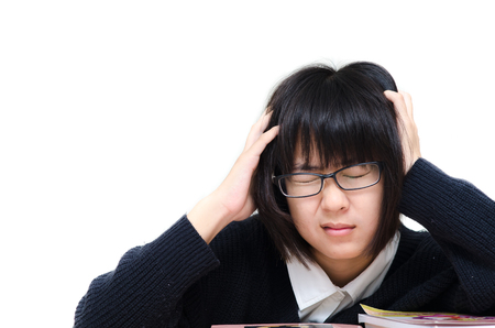 very tired/exhausted, pretty, female student with books working in a high school.の写真素材