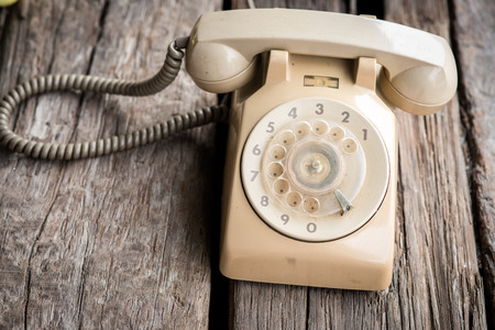 Retro rotary telephone on wood background.の写真素材