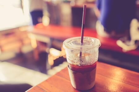 Ice coffee cup in cafe.  Photo filter effect.の写真素材