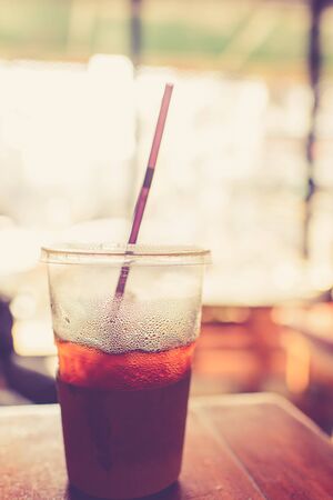 Ice coffee cup in cafe.  Photo filter effect.の写真素材