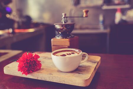 Love message on coffee cup on wooden background with vintage colour effect. Still life.の写真素材