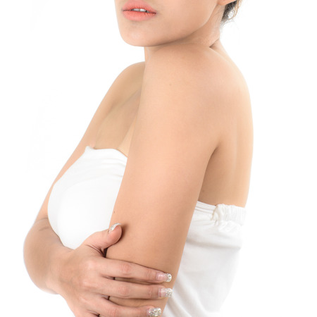 Close-up of a woman cares about her body, isolated on white.の写真素材