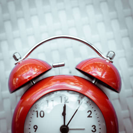 Retro alarm clock on  texture background.