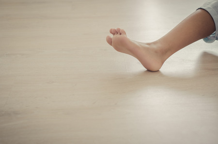 Feet of girl on wooen floor.