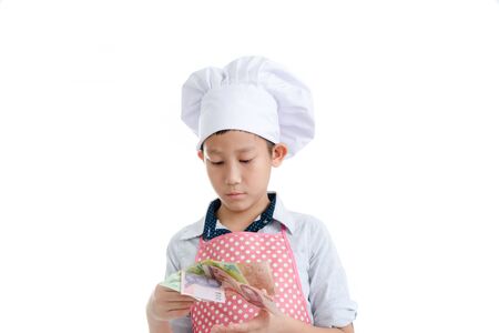 Young Asian cook holding Thai Baht in his hand.の写真素材