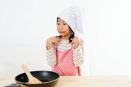 Asian girl cooking at home, food concept.の写真素材