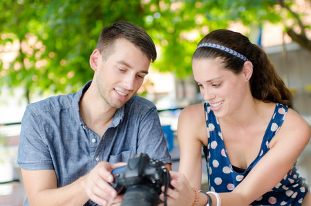 summer holidays and dating concept - smiling couple with photo camera in the parkの写真素材