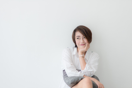 attractive asian woman sitting on the floorの写真素材