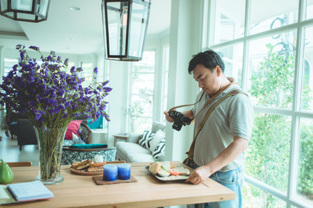 Asian photographer shooting food pictureの写真素材