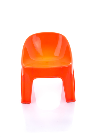 Orange plastic chair on isolated white background with reflection.の写真素材