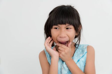 Young Asian gurk portrait action sleepy on gray background.の写真素材